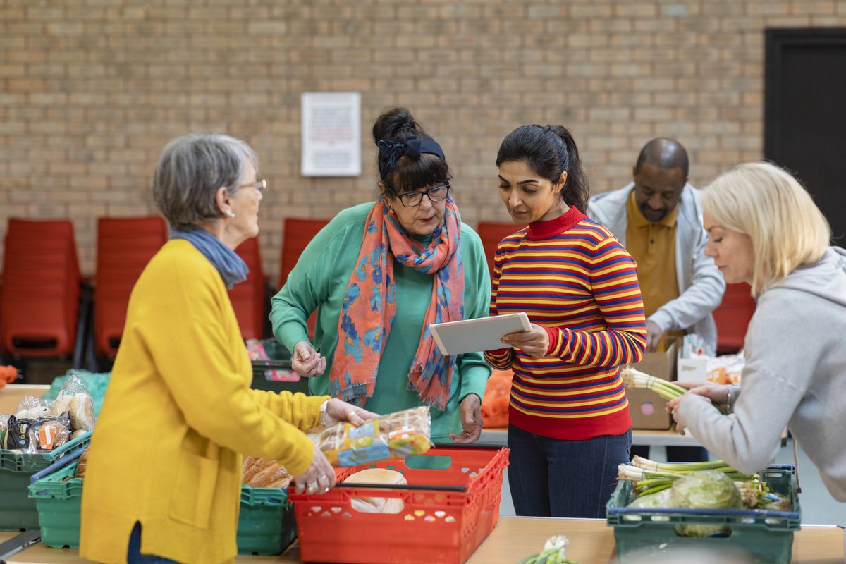 Volunteers organising stock at a charity food bank
