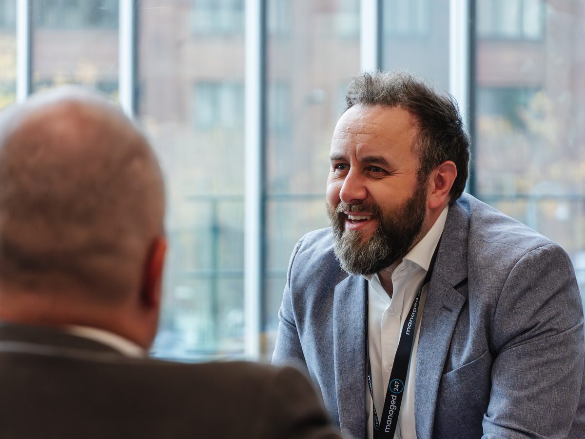 Managed247 team member in conversation with a client