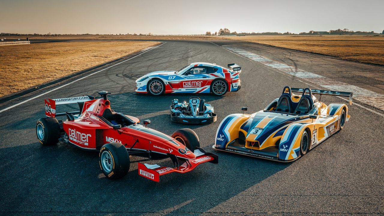 PalmerSport race cars on track at Bedford Autodrome at sunset
