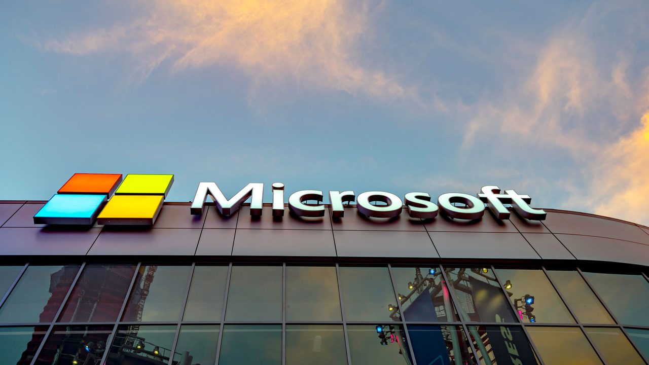 The Microsoft logo on a Microsoft building at dusk